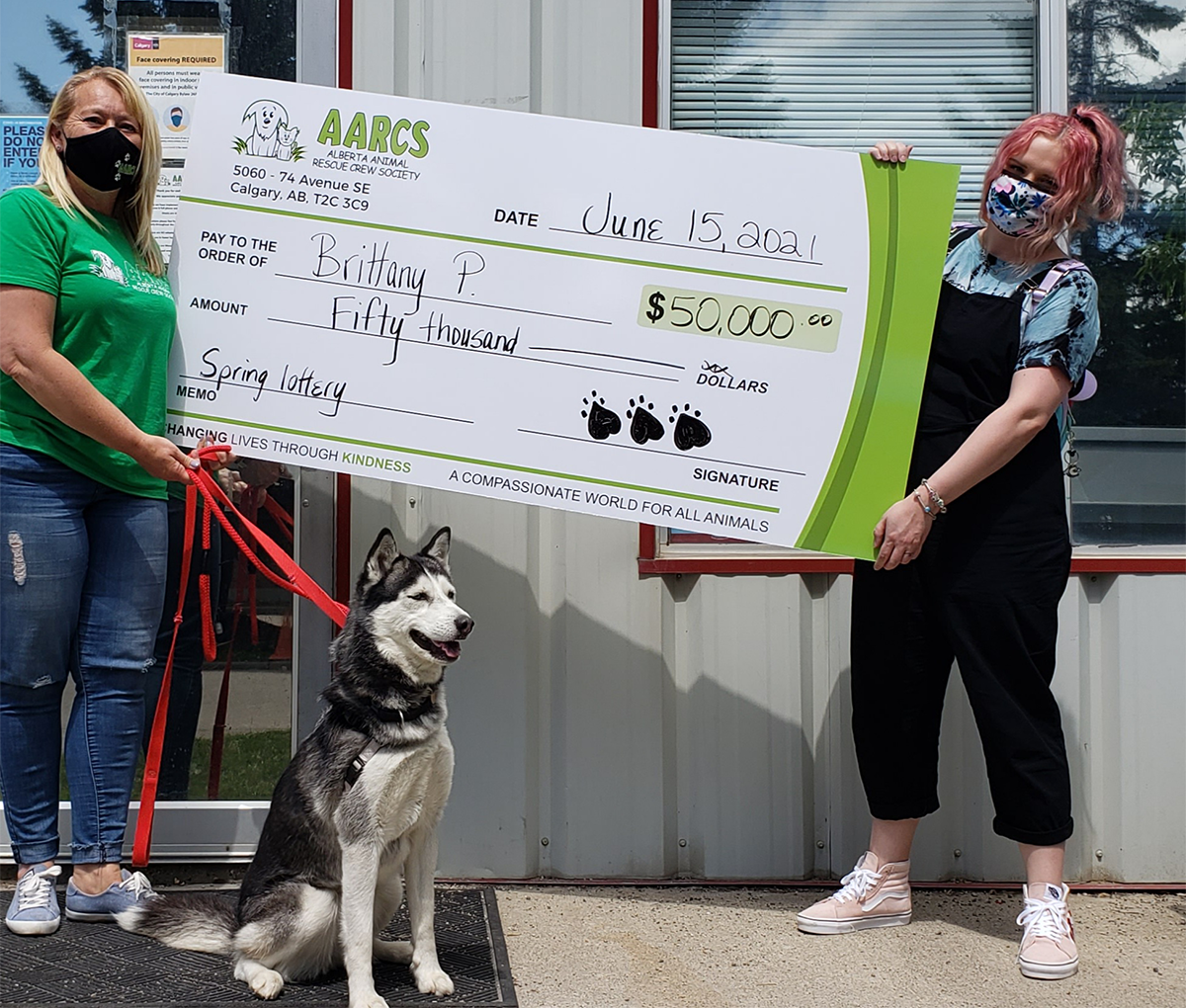 Nicole Janke and AARCS (adoptable dog) present $50,000 cheque to Grand Prize winner Brittany P.